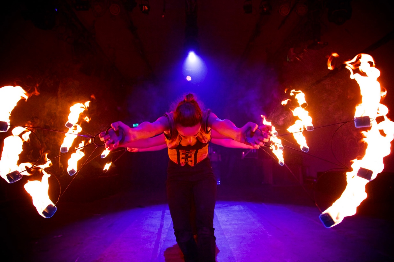 A girl flame throwing at vault festival