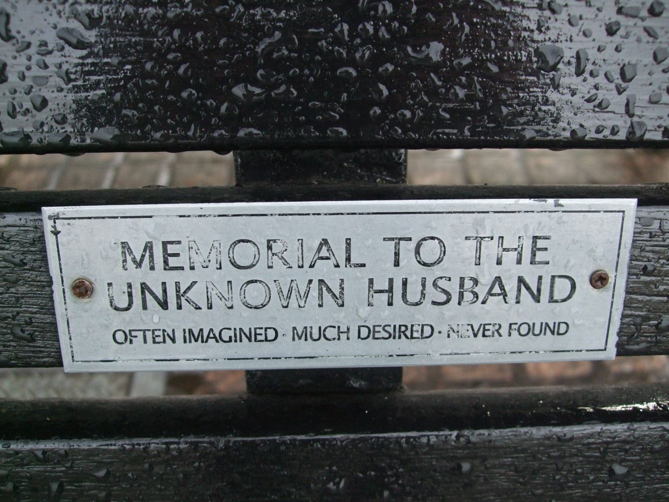 the plaque on the bench reads Memorial to the Unknown Husband