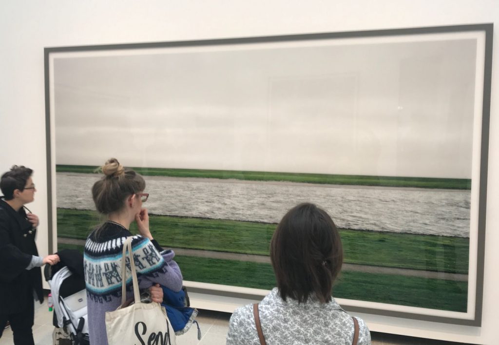 Three spectators gaze at Andreas Gursky photo